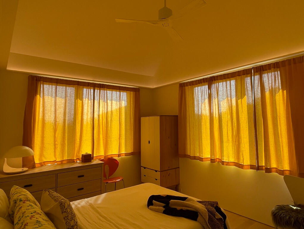 Bedroom cove so the cathedral ceiling can bounce light back into space. Those curtains make the room GLOW!