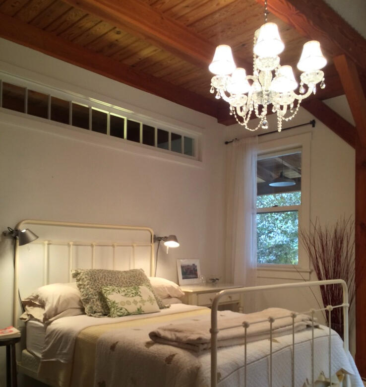 The Guest room gets a touch of elegance with a cyrstal chandelier and practicality from Tolomeo reading lamps.